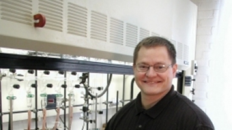 Ned Bowden photo next to a fume hood in the lab