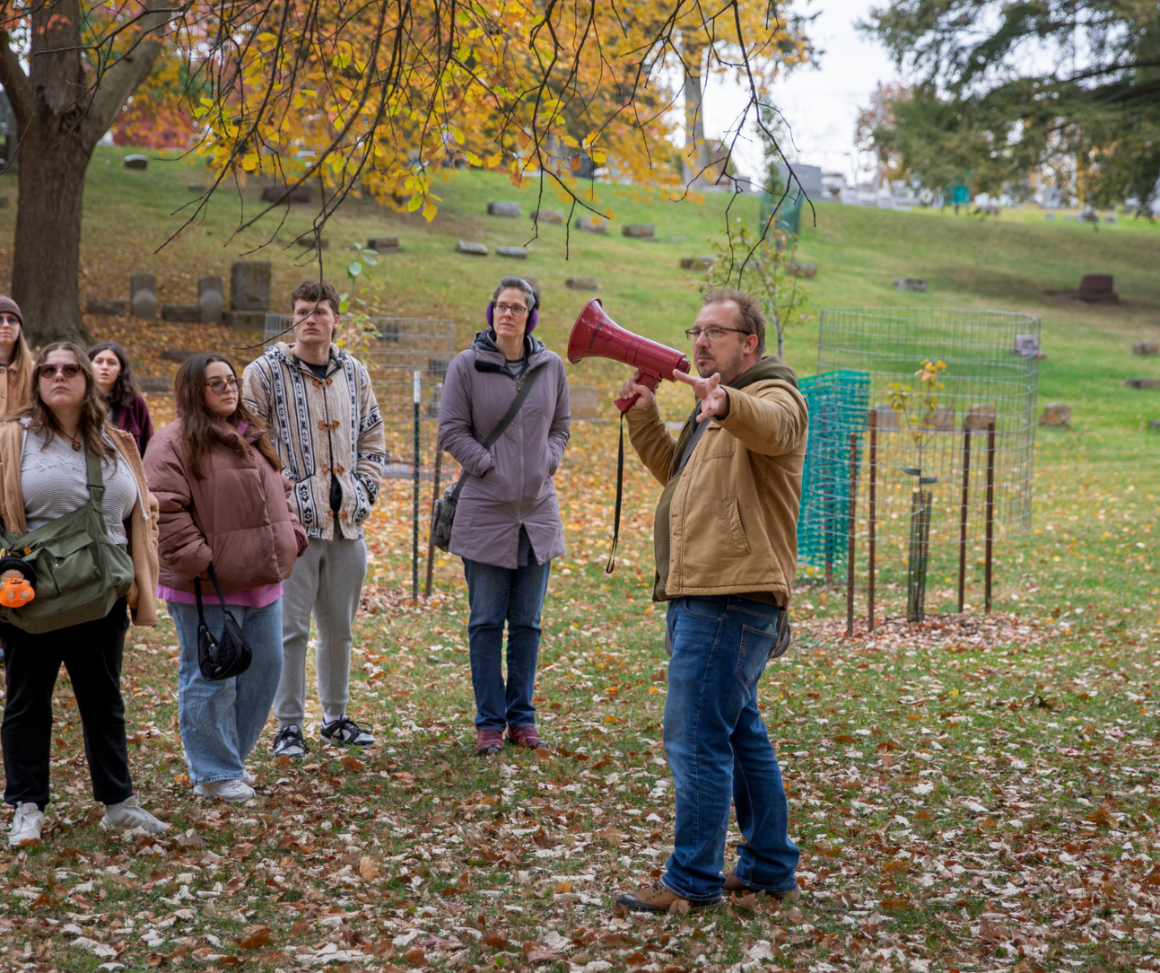 brandon dean with a megaphone in the cemetery 