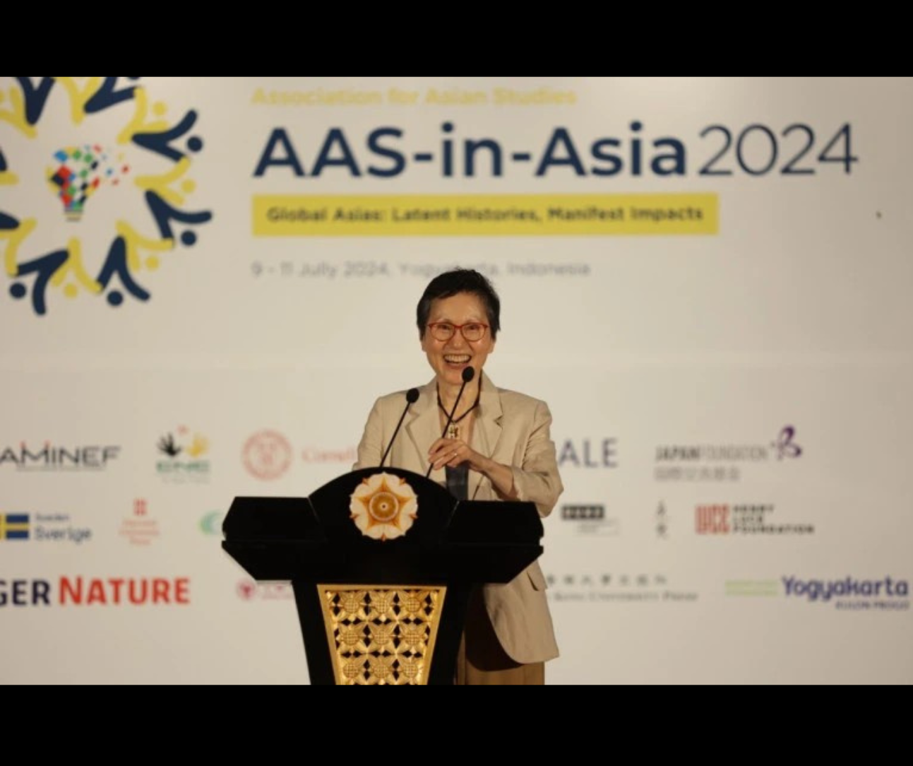Dr. Hyaeweol Choi onstage at the AAS meeting 2024