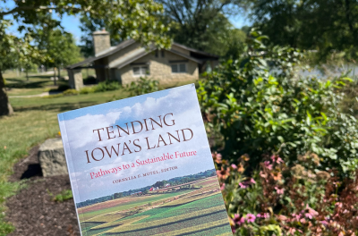 Tending Iowa's Land Book in front of Lagoon House