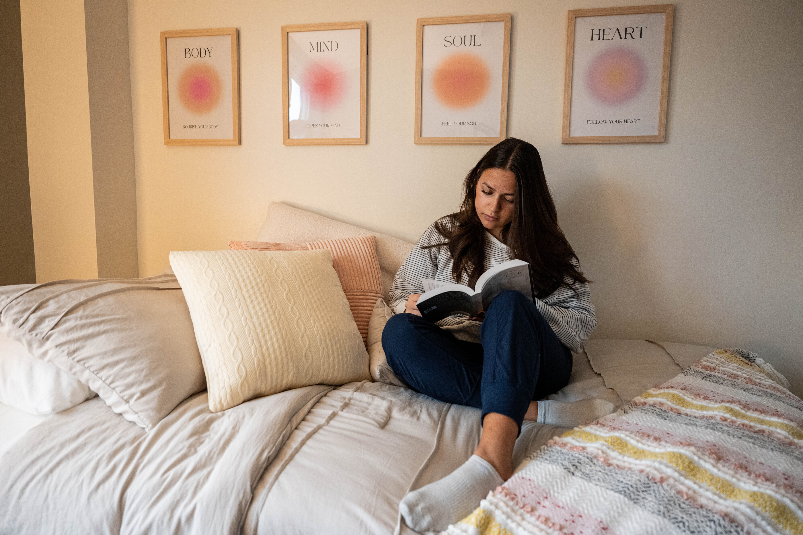 A woman in a cozy room writes in a notebook
