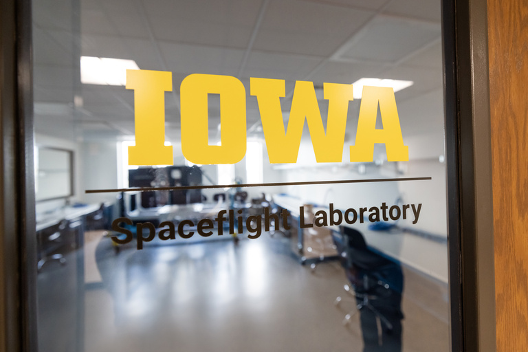 An image of a window with a decal that states, "Iowa Spaceflight Laboratory"