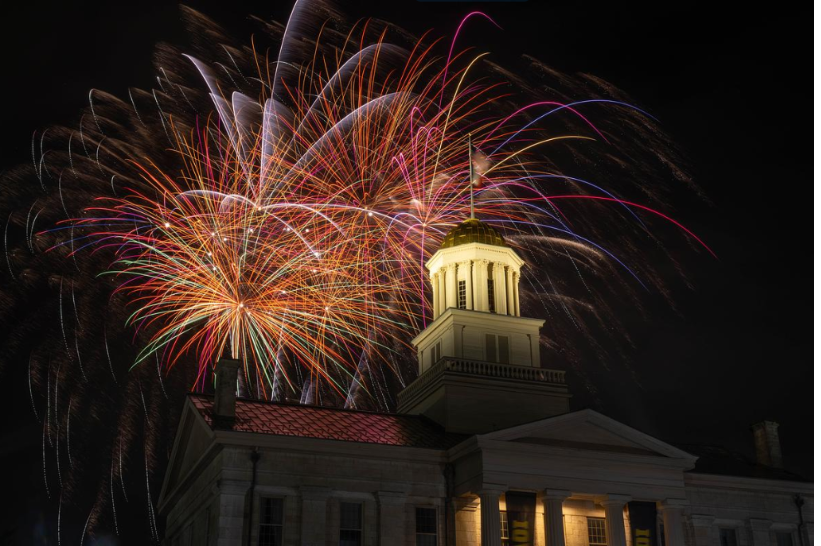Image: Old Capitol at night with fireworks in the sky