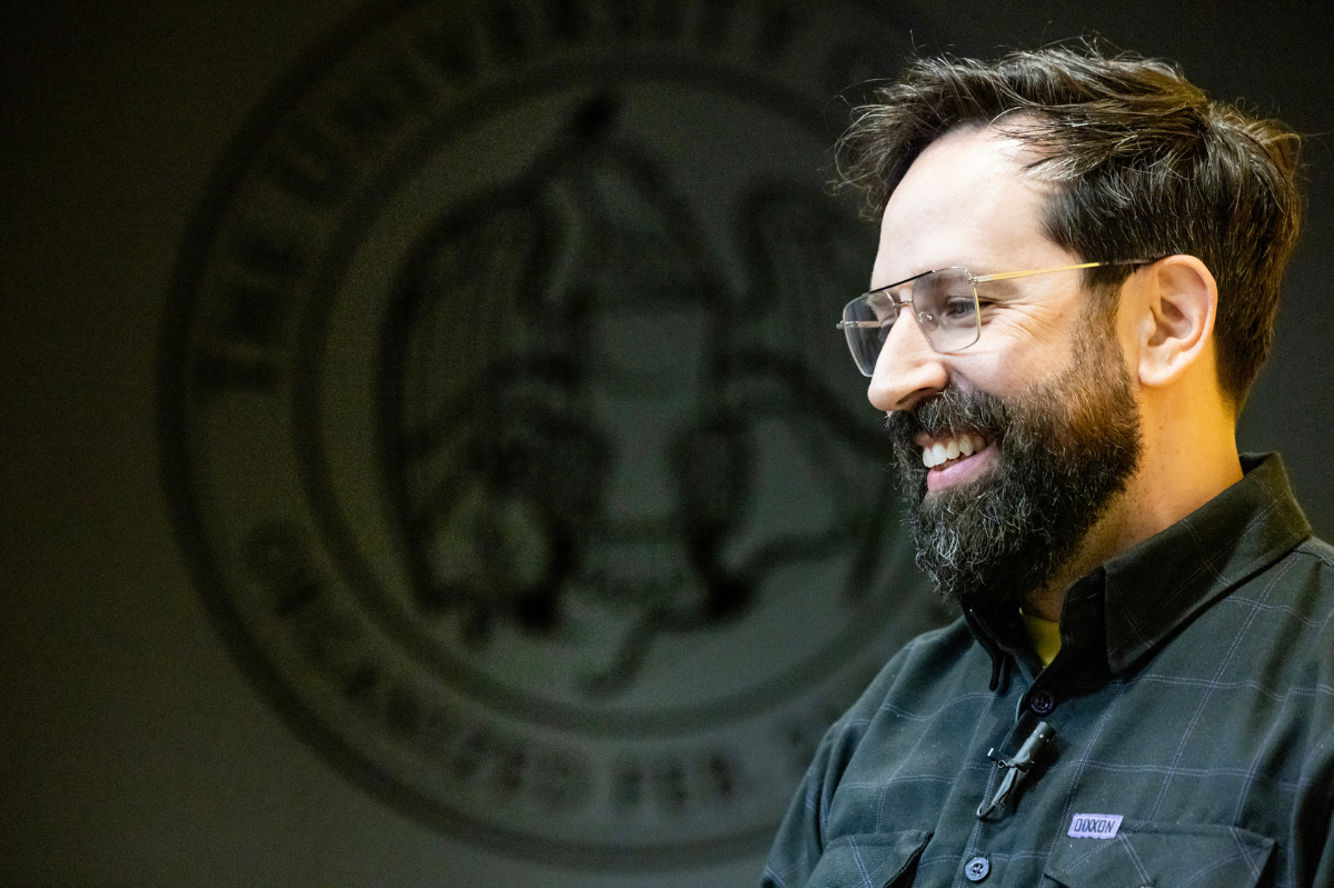 Eric Leiderman's smiling profile against a black background with the University of Iowa seal.