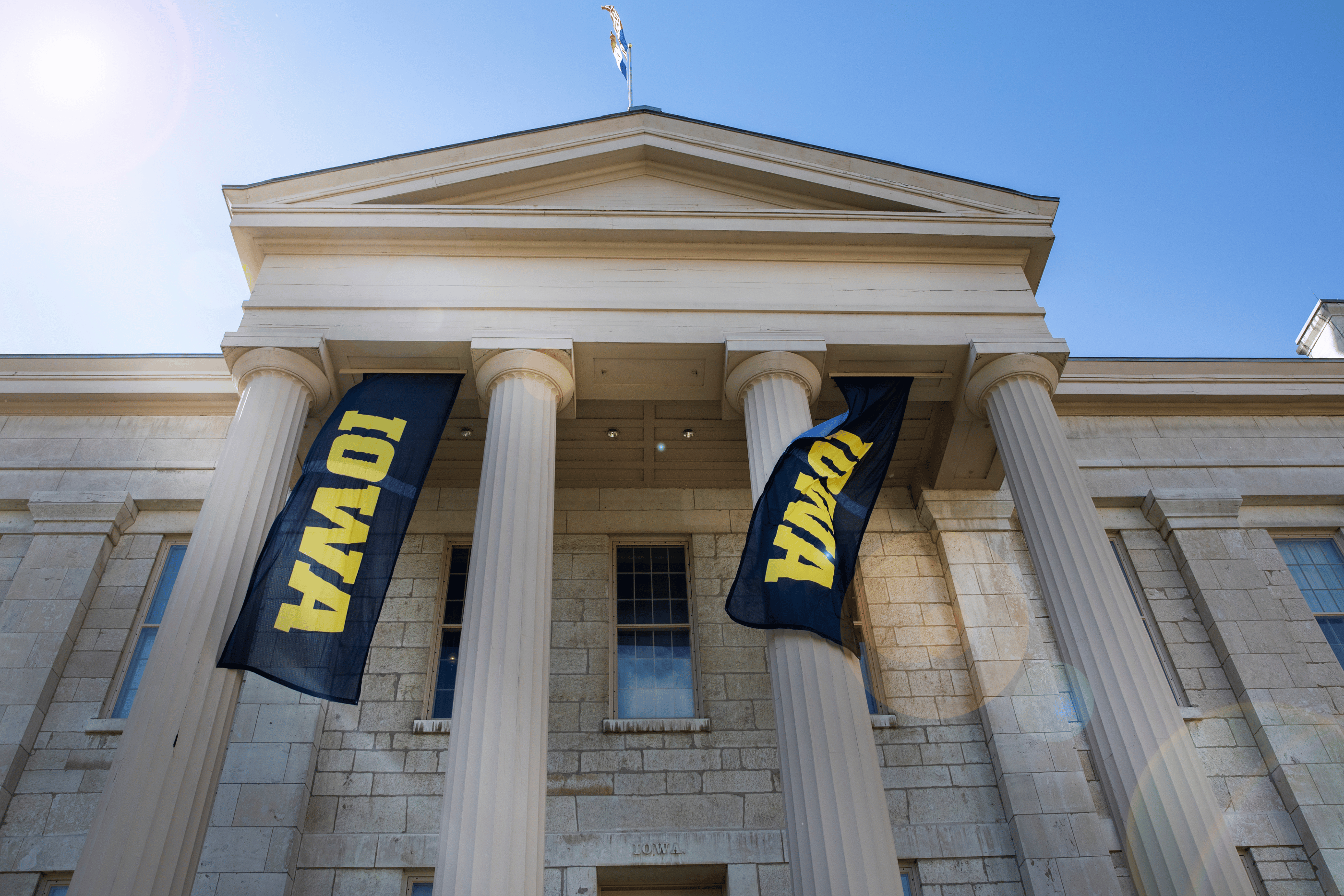 Schaeffer Hall with Iowa Banners flanking the columns