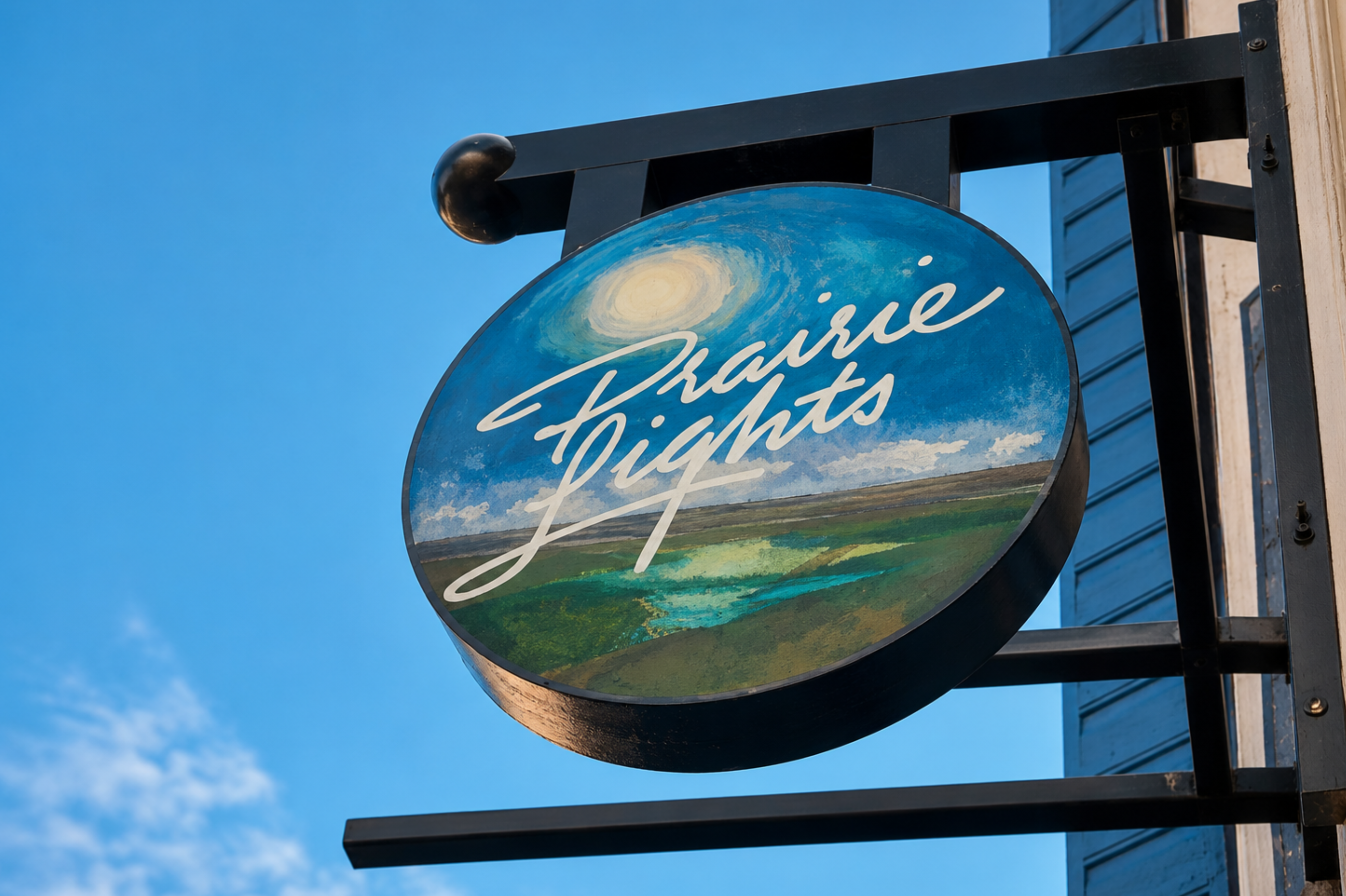 The circular Prairie Lights Books sign hangs outside the bookstore in downtown Iowa City.