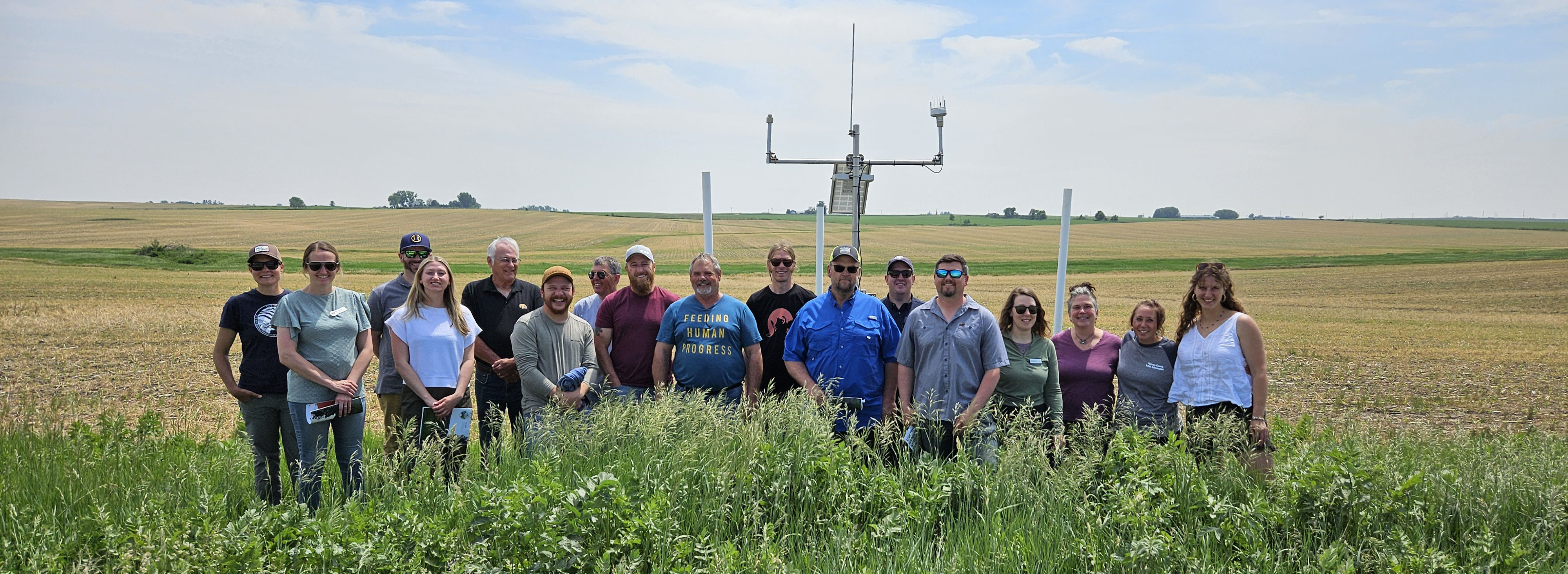 Watershed professionals from Iowa and Wisconsin posing in front of a hydrostation in northeast Iowa. 