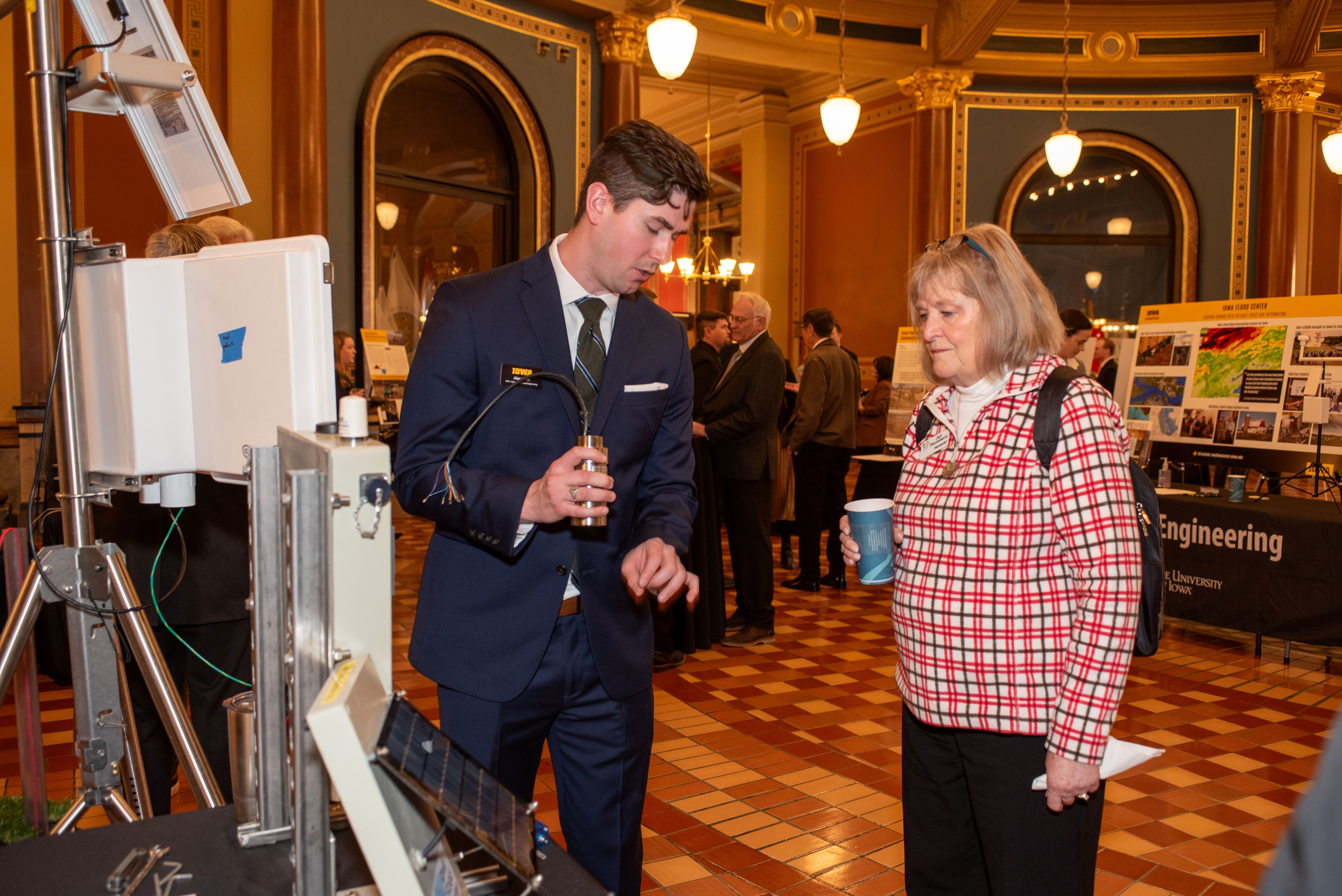 Alan Doran (IFC) discuss the hydrostation eqiupment with IFC Legislative Breakfast attendee)