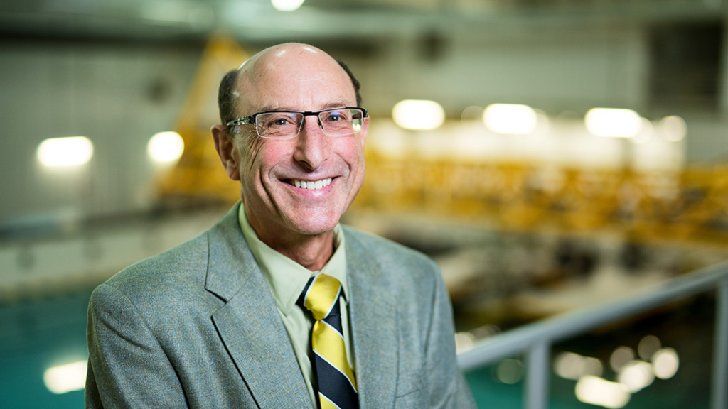 Man stands in front pool