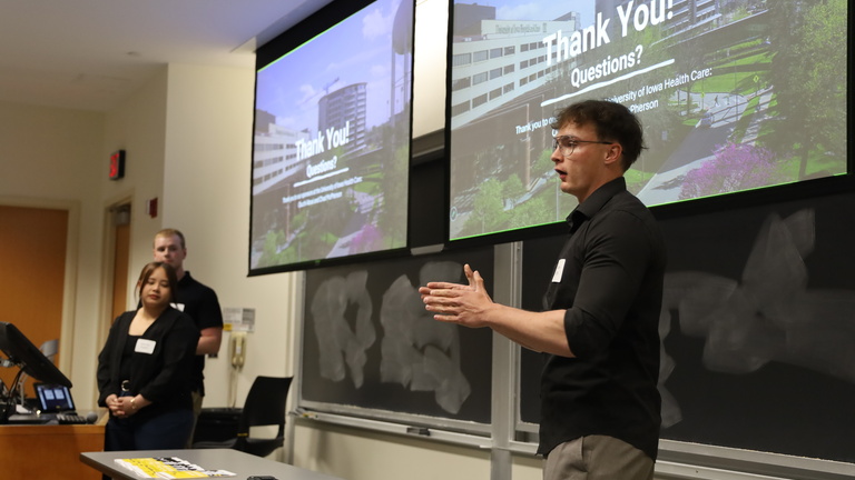 A student gives a presentation to an audience