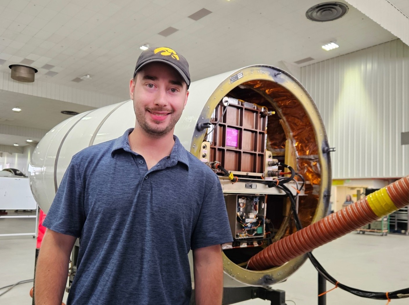 Graduate student Grant Finneman stands in front of the Cloud Physics Lidar instrument prior it to being mounted on the ER-2 high-altitude research aircraft