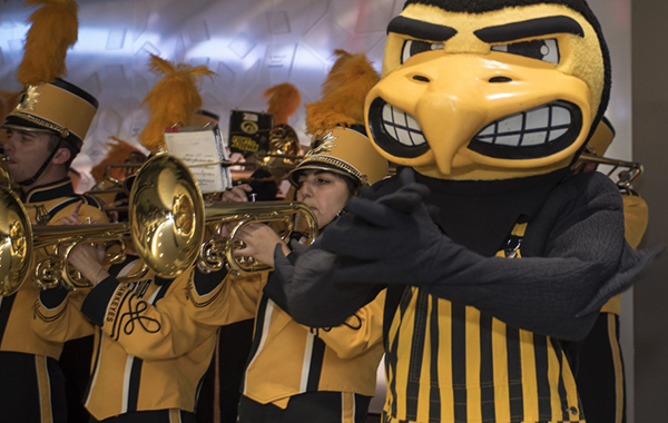 Herky the Hawk in front of a few members of the Hawkeye Marching Band