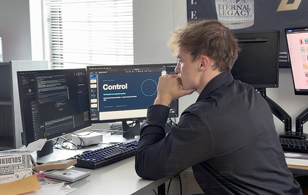 Engineering student Connor Vicory sits and works at his computer 