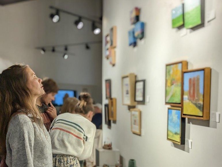 woman looking at art in an exhibition
