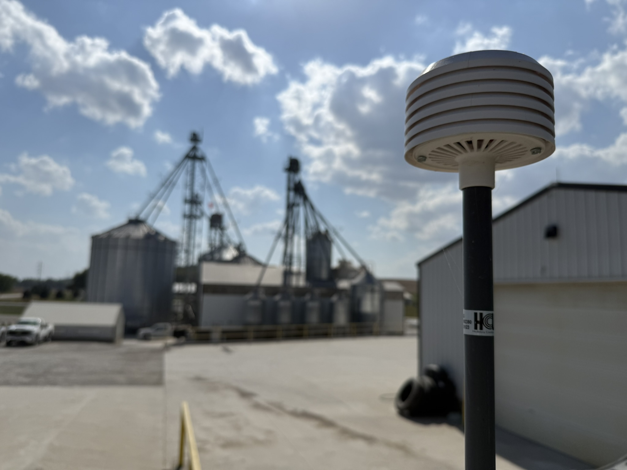 scientific sensor with a farm in the background