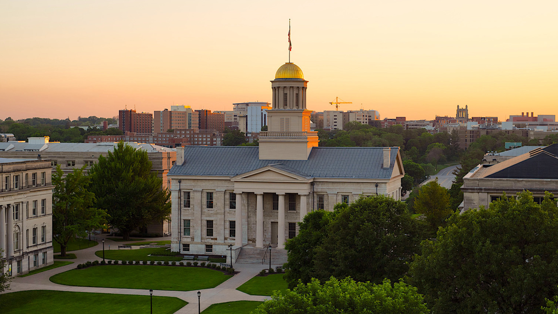 Sun sets behind the Old Capitol Building on campus