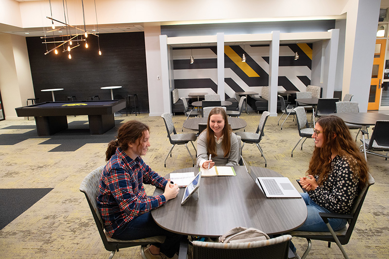 Three students working together in a University of Iowa study space. 