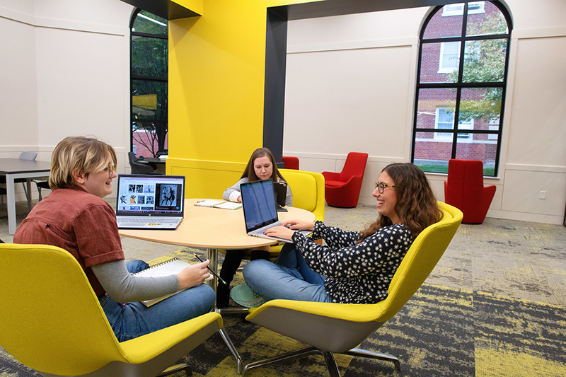 Three Iowa students in a study space.