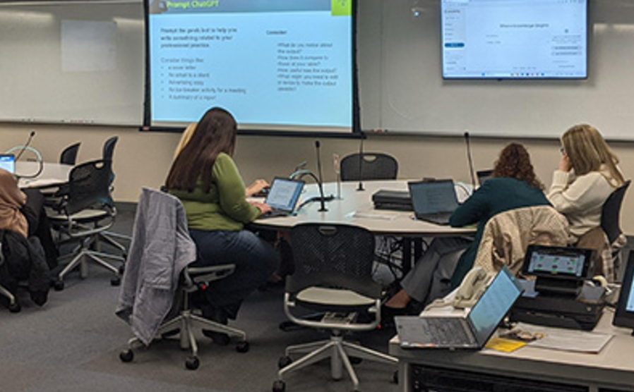 UI faculty and staff engage with AI in a TILE room in the Main Library.