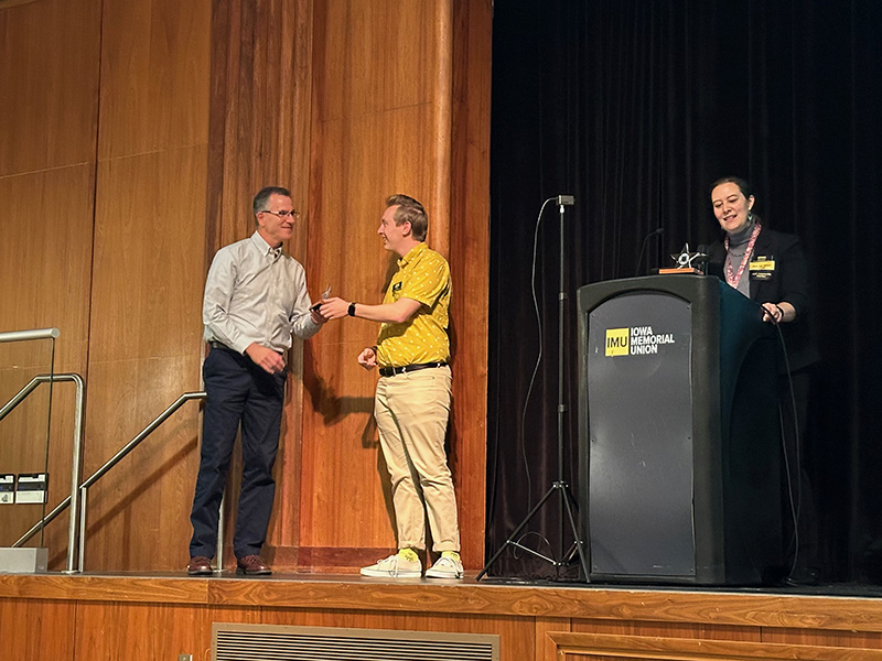 Vicky and Mitch presenting an ICON All Star Award to an instructor.
