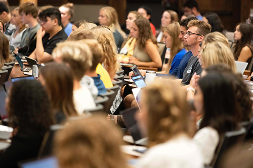UI students attend class in a MacBride Hall, a large enrollment classroom.