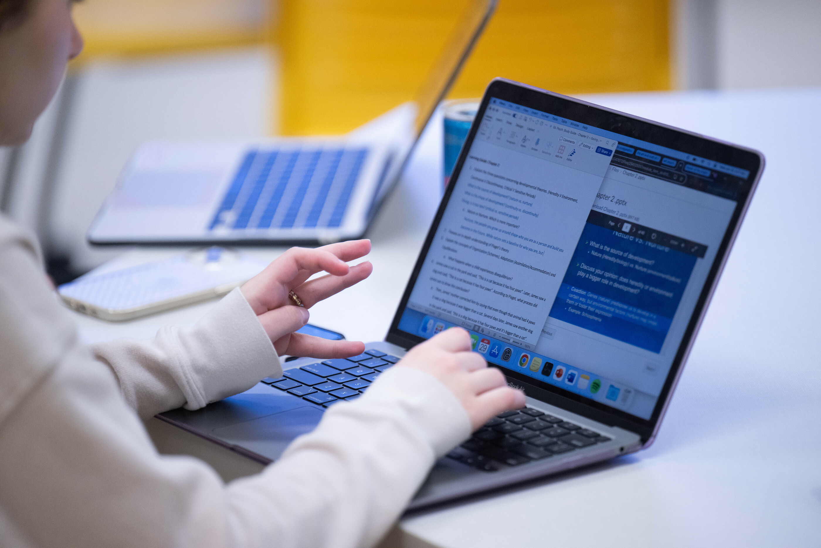 Closeup of student using computer for homework.