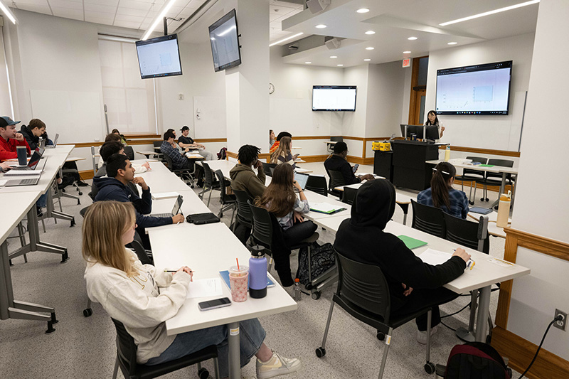 UI students sit at rows of desks.