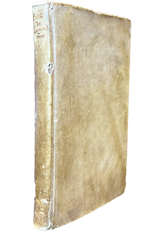 Color photo of the limp vellum cover from Petit's "De lacrymis" with the title written at the top of the spine, 1661.
