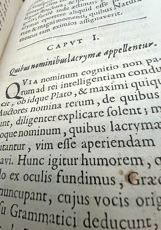 Color photo of the start of the chapter "Quibus nominibus lacrymae appellentur," from Petit's De lacrymis, 1661.