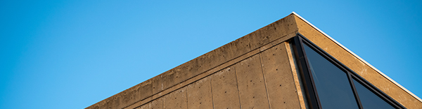 Roofline of the Hardin Library for the Health Sciences with a blue sky above it.
