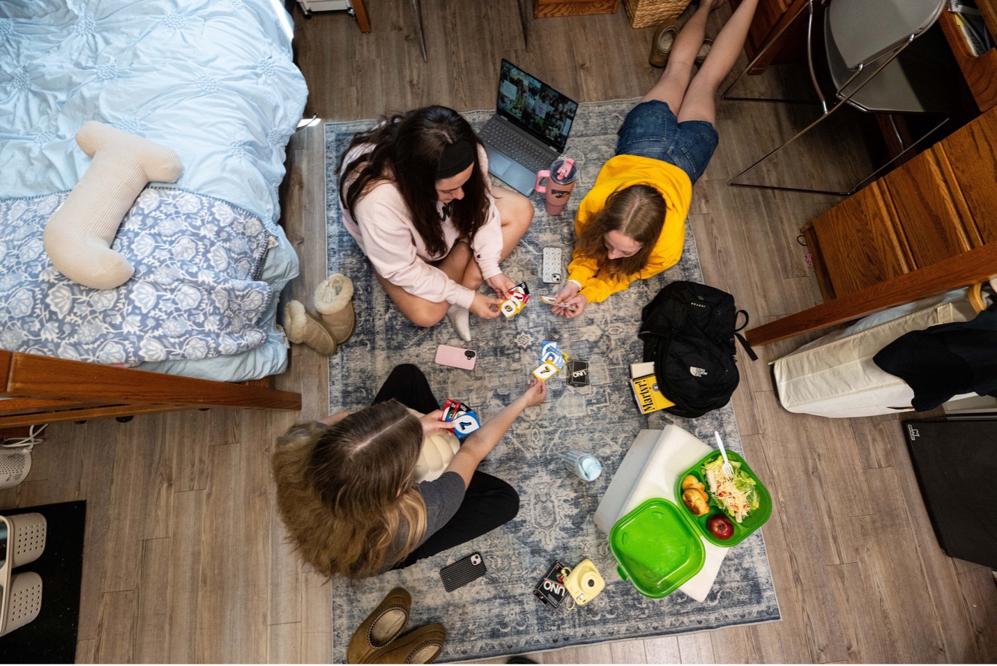 image of students playing Uno and studying for finals