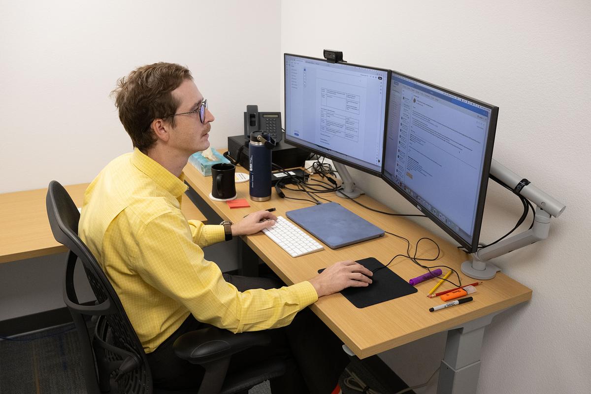 CSSI Researcher-in-Residence Bogdan Kapatsila working at a computer.
