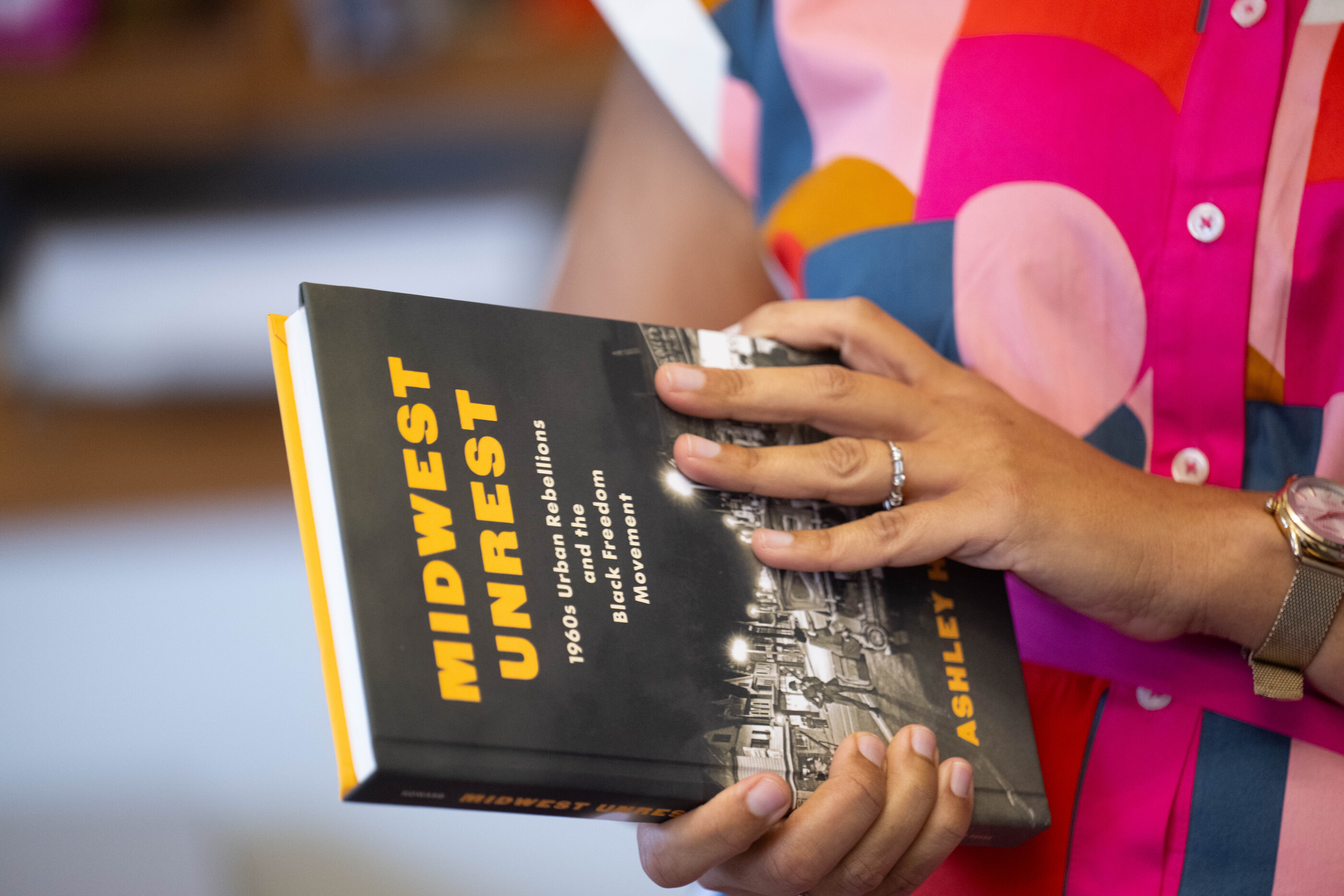 Ashley Howard holding her book, Midwest Unrest