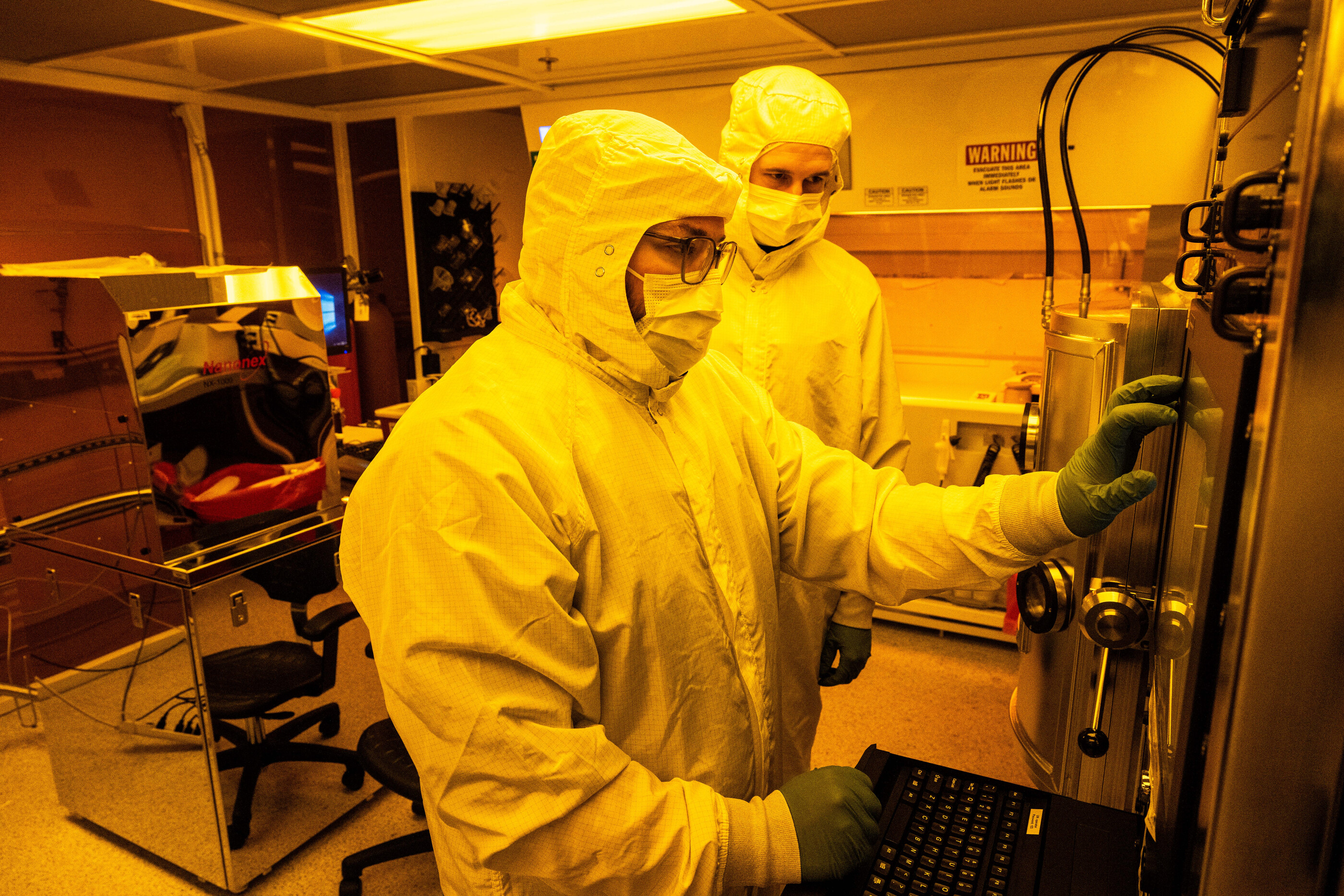 two scientists work in a clean room 