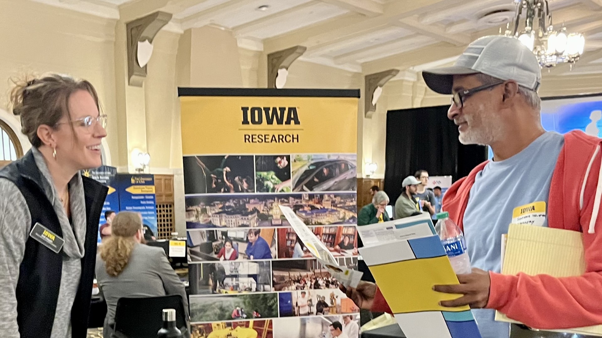 A vendor and a researcher chat at the 2024 Research Services Fair