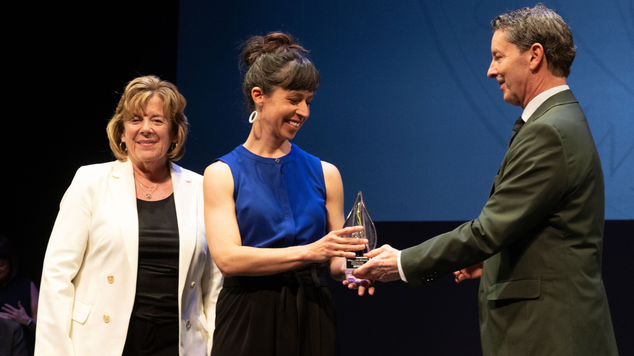 stephanie miracle accepts an award