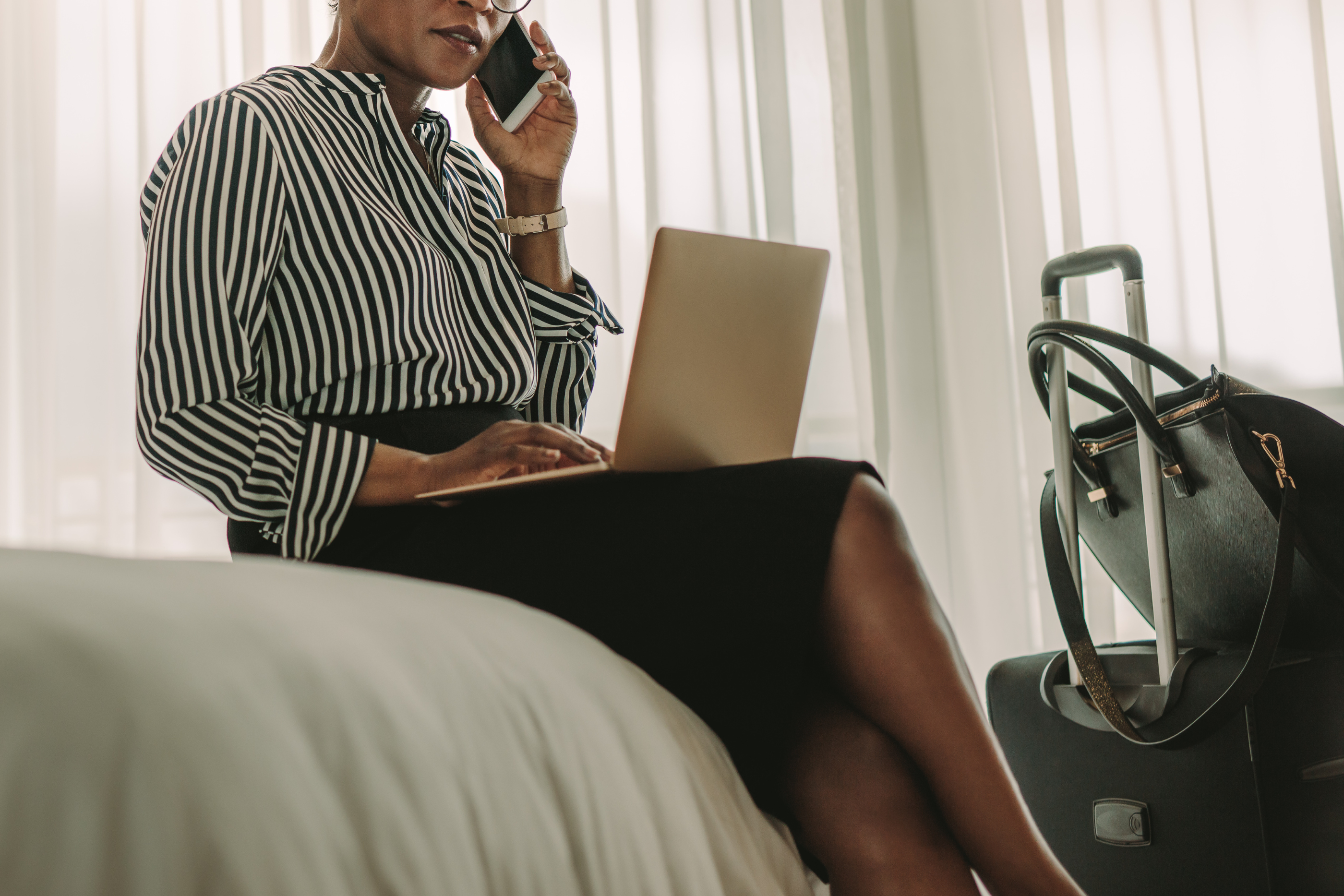 person working on a laptop in a hotel room