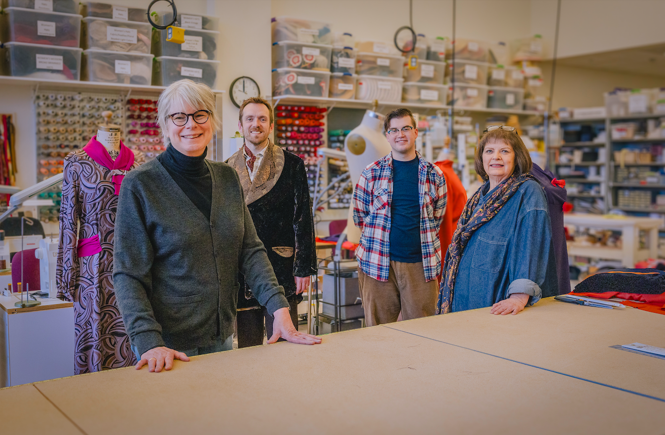 Margaret Wenk-Kuchlbauer with others at a costume fitting