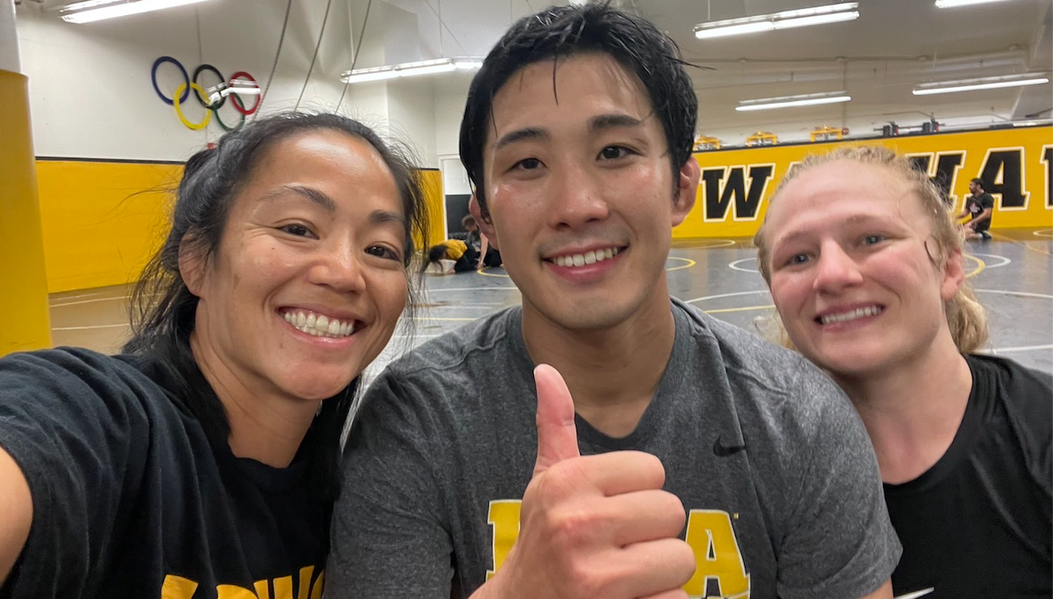Keisuke Otoguro  with members of Iowa women's wrestling team