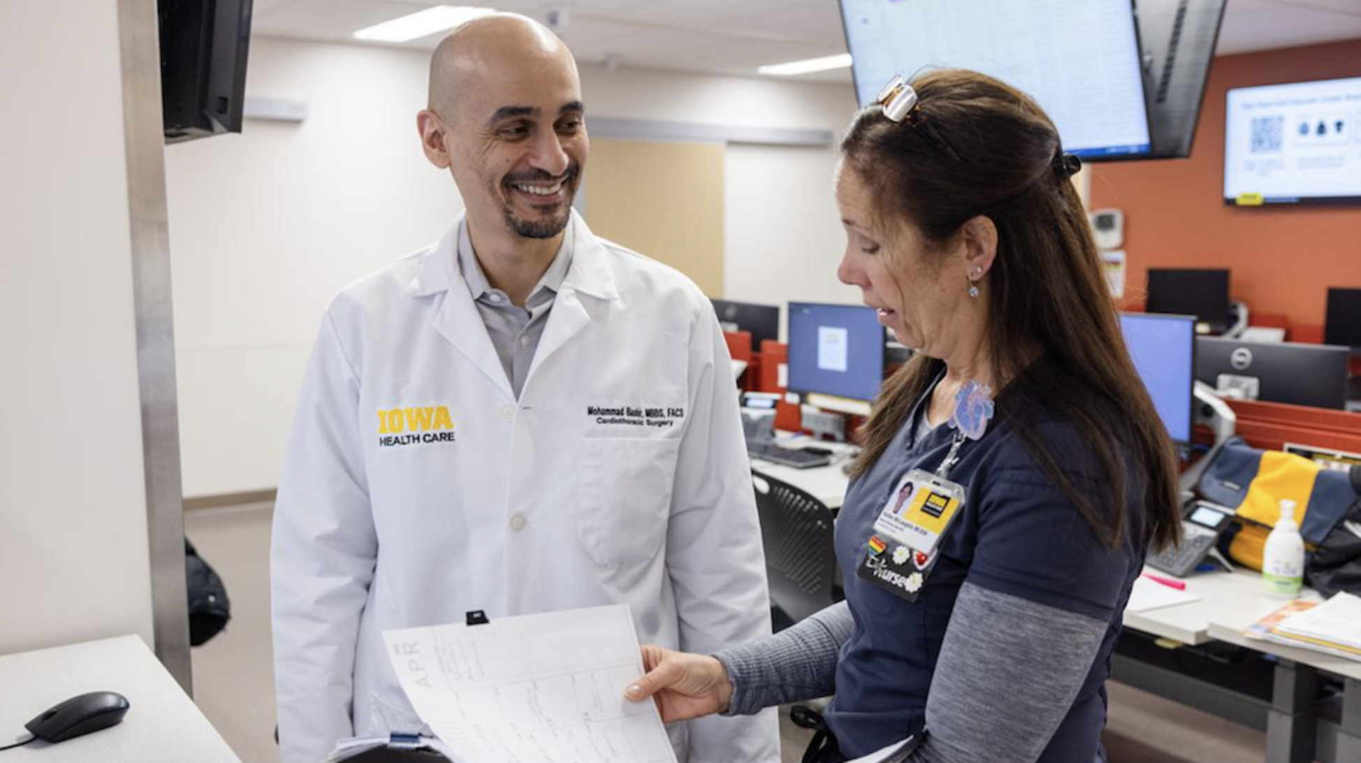Surgeon Mohammad Bashir speaking with colleague 