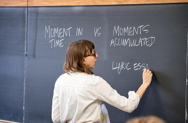 Person writing on a chalkboard