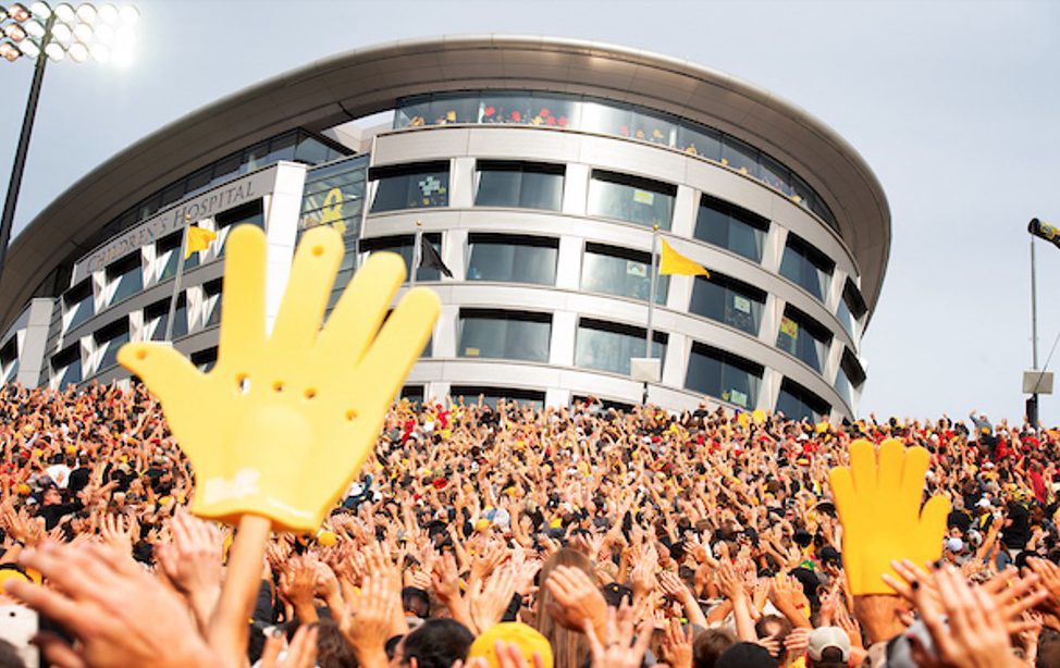 People doing the Wave at a football game