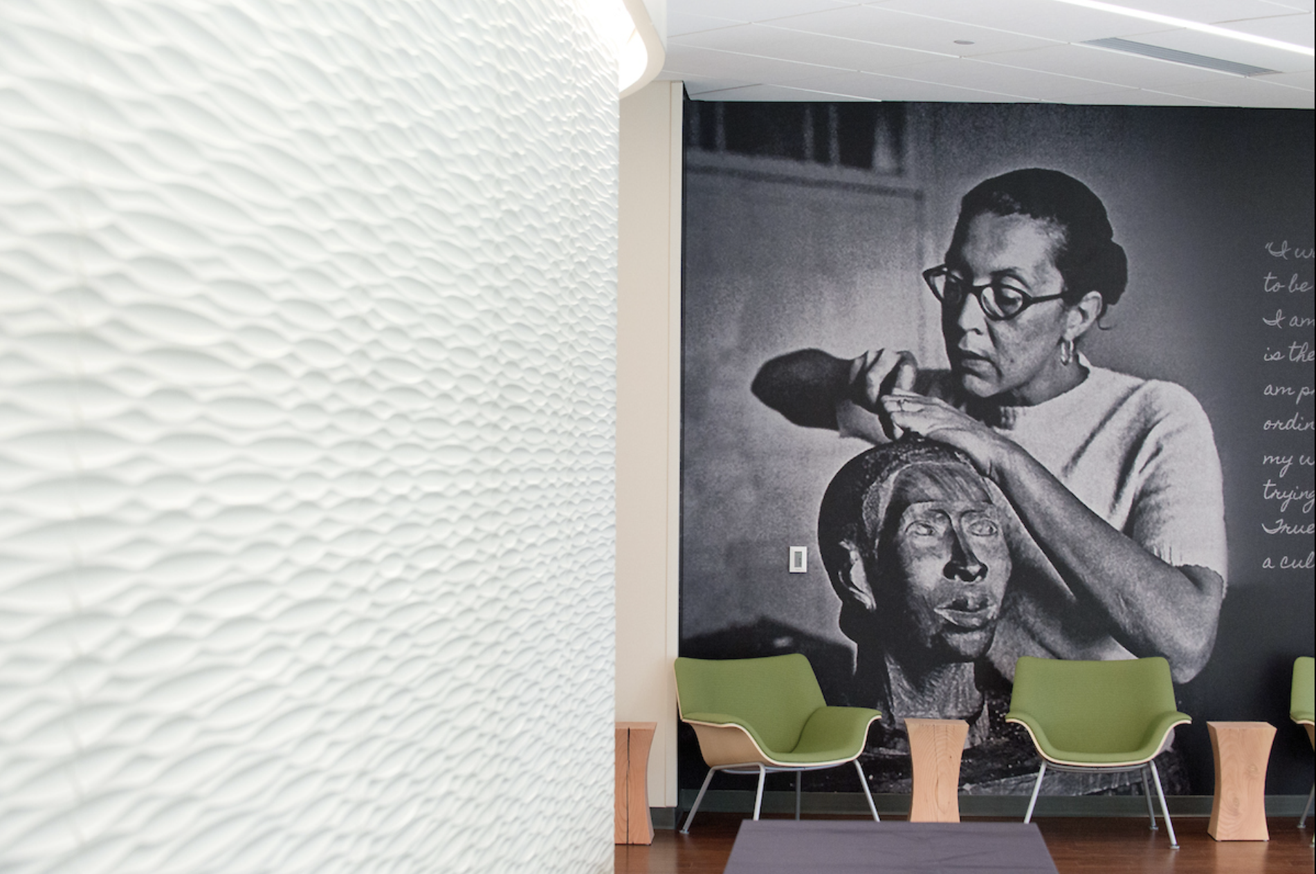Photo displayed in Catlett Residence Hall of Elizabeth Catlett working on a sculpture 