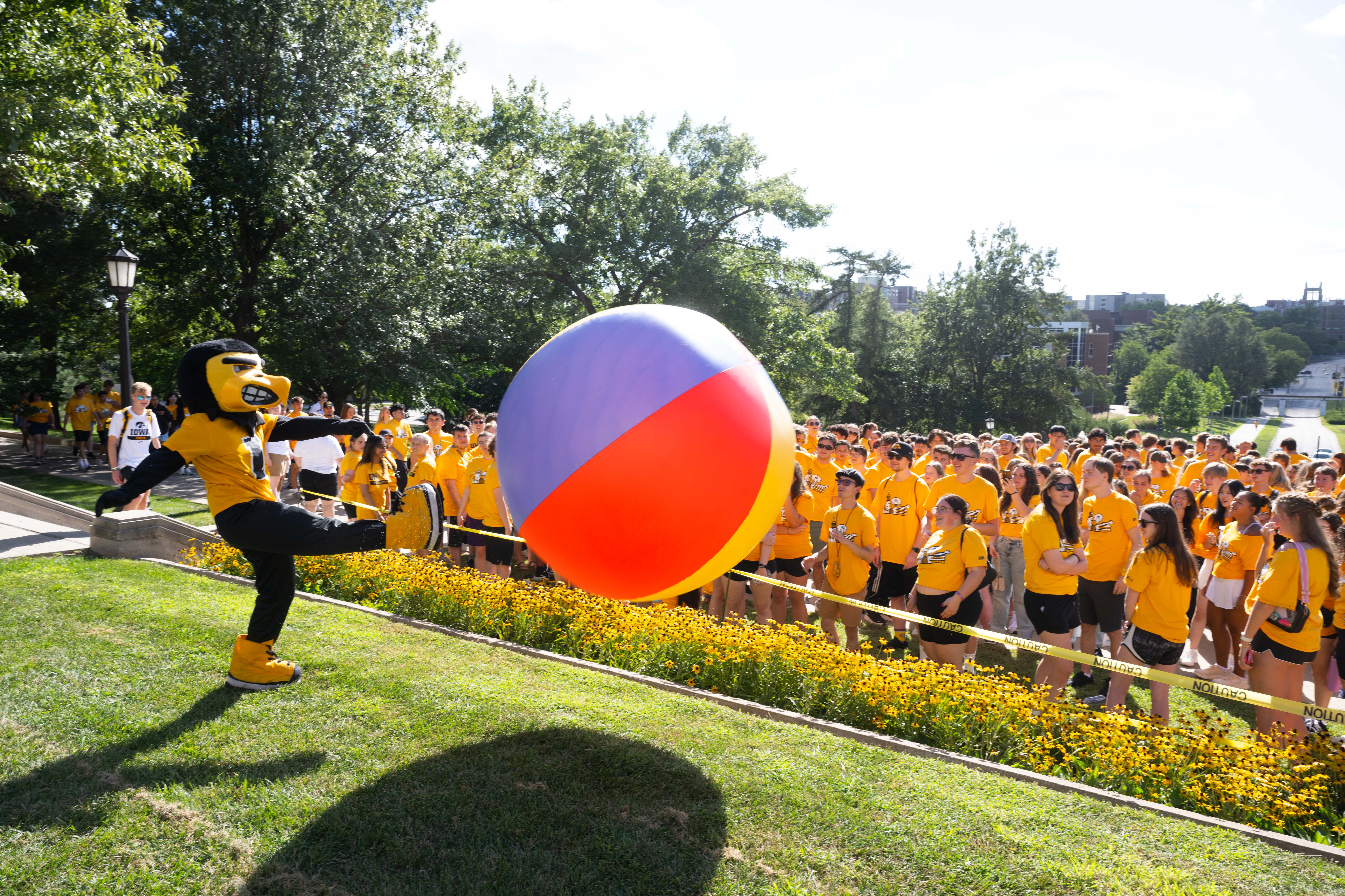 Herky kicking a beach ball
