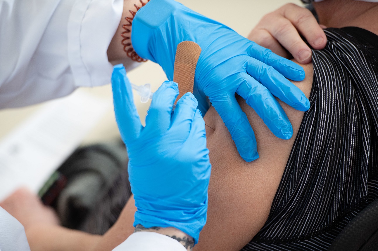 Close up of person receiving a bandage after a flu shot