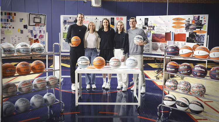 Christopher Rickert (left) and Caitlin Clark (center) with Wilson basketball team