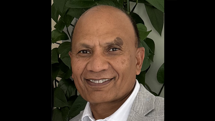 Farrukh Bashier, new AVP of Facilities Management, in a suit smiling.