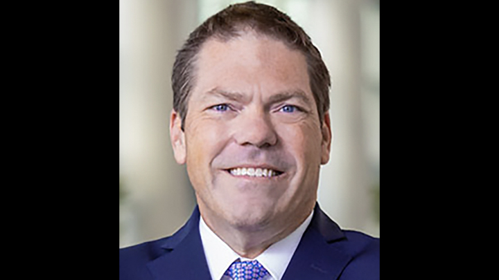 Brad Rohrer, new CIO, in a suit smiling