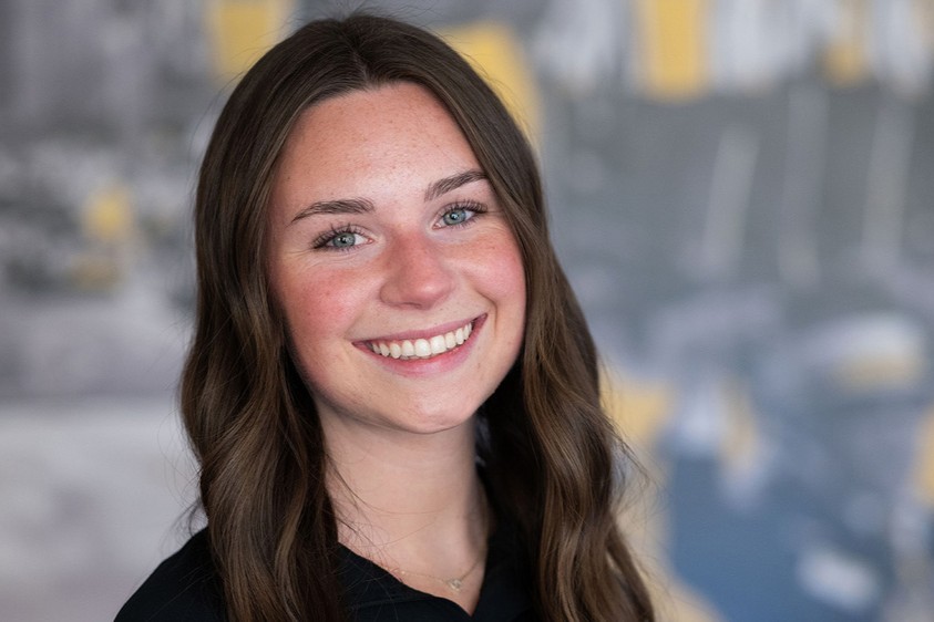 A close up of Amanda Earley - a female student with long dark hair and a big smile.