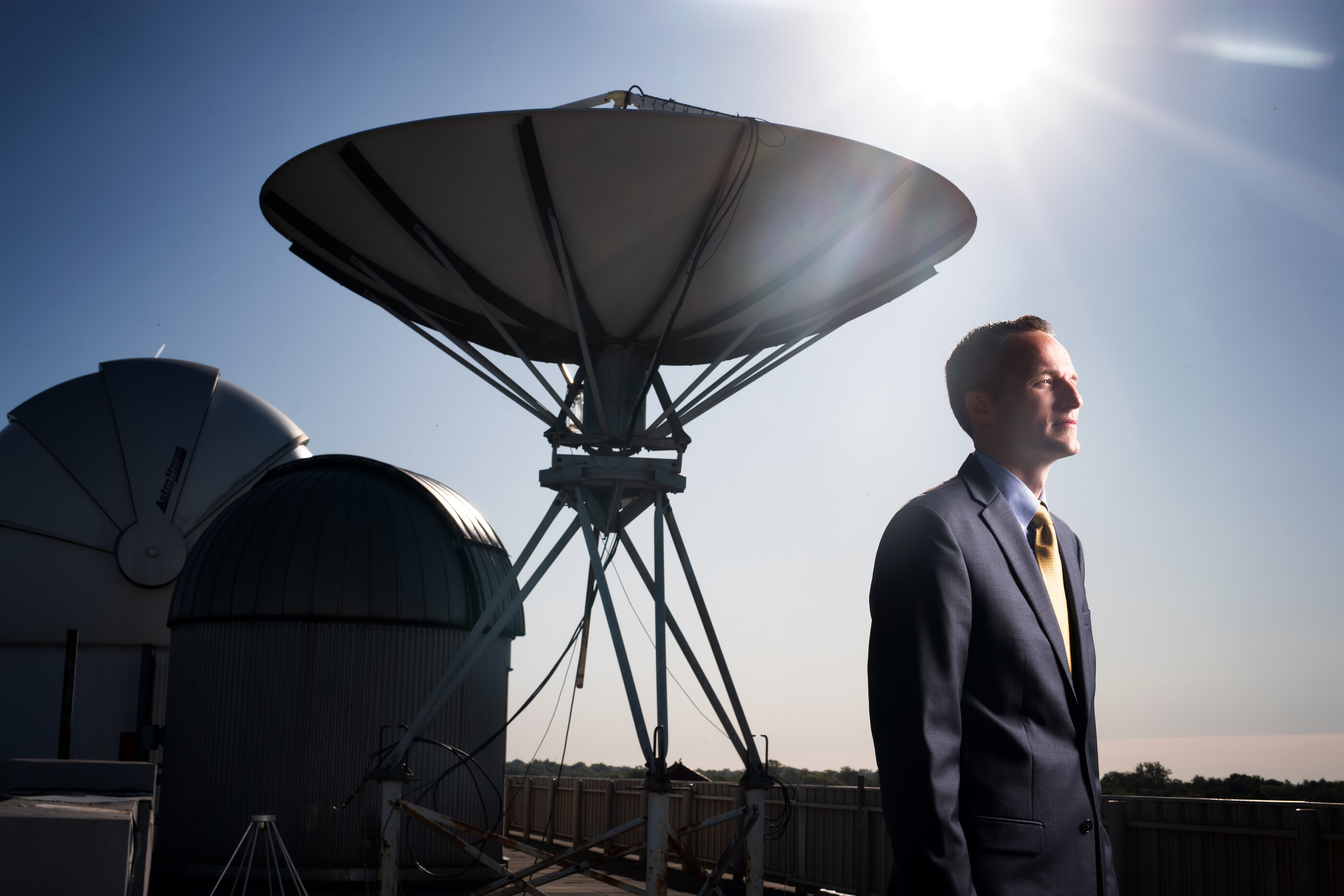 Daniel Newton in front of a sattelite dish
